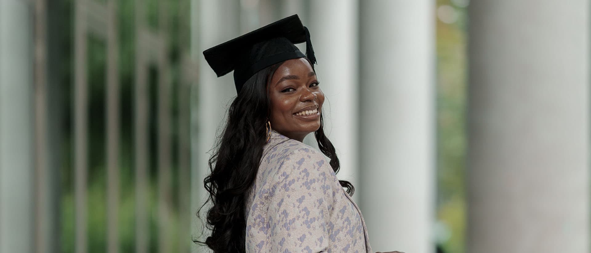 Graduate wearing a mortarboard and gown